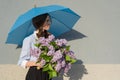 Girl with bouquet of lilacs, with an umbrella Royalty Free Stock Photo