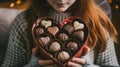 Girl with a box of chocolates in the shape of a heart, top view Royalty Free Stock Photo