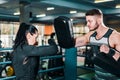 Girl boxer trains. coach holds boxing focus pads. athlete practicing shots in the gym. Royalty Free Stock Photo