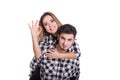 Girl on boy back showing ok sign isolated