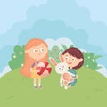 Girl and boy with ball and rabbit in the meadow, kids toys Royalty Free Stock Photo