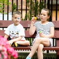 Girl and boy blowing soap bubbles Royalty Free Stock Photo