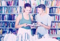 Girl and boy in book store Royalty Free Stock Photo