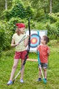 Girl and boy with bow near sport aim Royalty Free Stock Photo