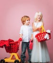 Girl and boy children shopping. Couple kids hold plastic shopping basket toy. Kids store. Mall shopping. Buy products Royalty Free Stock Photo