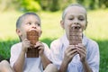 Girl and boy eating chocolate outdoors