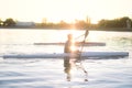 The girl or boy is engaged in rowing sitting in a boat rowing oars in rafting