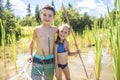 Cute girl and boy fishing with a net on a lake Royalty Free Stock Photo