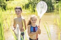 Cute girl and boy fishing with a net on a lake Royalty Free Stock Photo