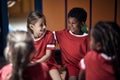 Girl and boy friends  in good mood  before training  in changing room Royalty Free Stock Photo