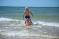 Girl and boy of having fun in water on beach and splashing Royalty Free Stock Photo