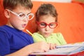 Girl and boy intently doing homework