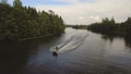 Girl and boy on the jet ski in the river.Aerial video.