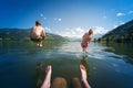 Girl and boy jumping in lake water Royalty Free Stock Photo