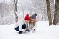 Young couple making snowman in forest