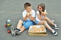 A girl and a boy are looking at big delicious pizza in a box Royalty Free Stock Photo