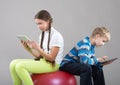 Girl and boy looking at Pad Tablet PC screens