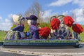 Girl and boy in native clothes from flowers. Flower parade