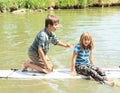 Girl and boy playing on surf Royalty Free Stock Photo