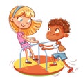 Girl and boy ride on small carousel. Amusement park