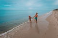 Girl and boy running at beach, kids play at sea Royalty Free Stock Photo