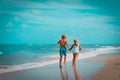 Girl and boy running at beach, kids play with waves Royalty Free Stock Photo