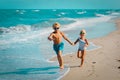 Girl and boy running at beach, kids play with waves Royalty Free Stock Photo