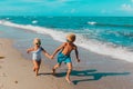 Girl and boy running at beach, kids play with waves Royalty Free Stock Photo