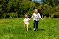 Girl and boy running on the grass Royalty Free Stock Photo