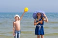 Girl and boy show that it is necessary to take from the sun on the sea