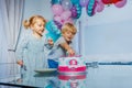 Girl and a boy sit at birthday party pointing to cake Royalty Free Stock Photo