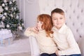 Girl and boy. Small children. Bright interior. Horizontally