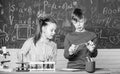 Girl and boy smart students conduct school experiment. School education. Chemical analysis. Kids busy study chemistry