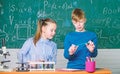 Girl and boy smart students conduct school experiment. School education. Chemical analysis. Kids busy study chemistry