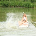 Girl and boy splashing on surf Royalty Free Stock Photo