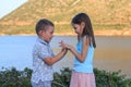 Girl and boy together outdoors. small brother playing with older sister