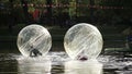 Girl and boy in water ball in open swimming pool
