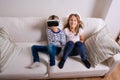 Girl and boy wearing virtual reality goggles. Studio shot Royalty Free Stock Photo