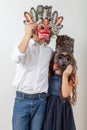 Girl and boy in wooden Native American masks