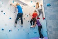 Girl and boys hanging on wall and coach supporting Royalty Free Stock Photo