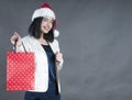 Girl with braces a cap santa gift bag Royalty Free Stock Photo