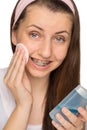 Girl with braces using makeup removal Royalty Free Stock Photo