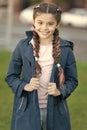 Girl with braided hair style with pink kanekalon. Add bright detail. Little girl with cute braids wear dark coat nature