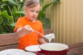 Girl at breakfast porridge scoop ladle