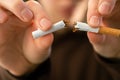 Girl breaks a cigarette in her hands, view closeup.