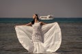 Girl bride posing in wedding dress with ship in sea Royalty Free Stock Photo