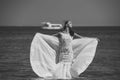 Girl bride posing in wedding dress with ship in sea Royalty Free Stock Photo