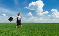 Girl with a briefcase walking on grass Royalty Free Stock Photo