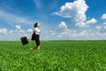 Girl with briefcase walking on the grass Royalty Free Stock Photo