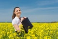 Girl with briefcase on yellow flower field Royalty Free Stock Photo